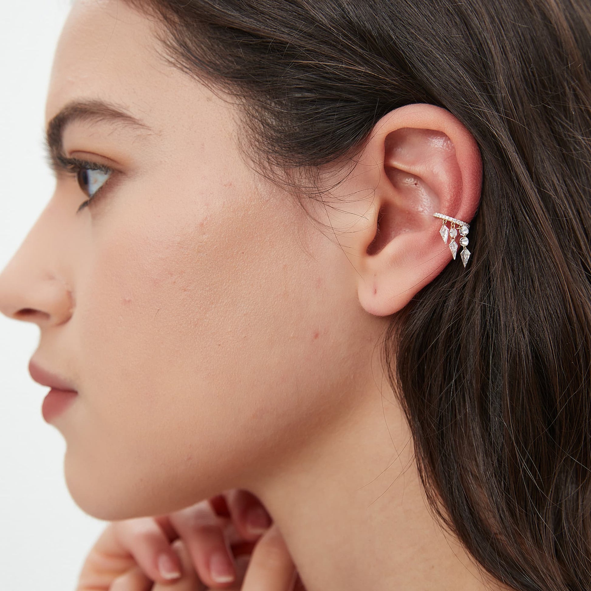 Model wearing the triple-row kite diamond climbing ear cuff