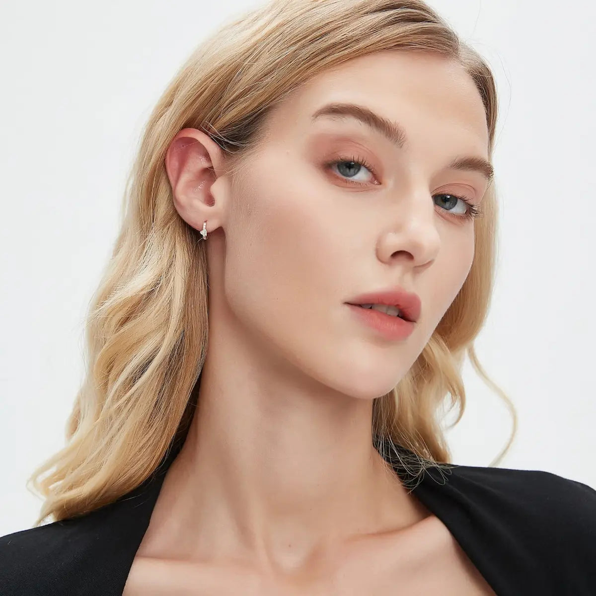A technical side profile view of the Heart Pavé Hoop. This image highlights the structural integrity of the 18K solid gold AU750 construction and the seamless integrated hinge closure designed for secure 24/7 permanent wear. The side perspective showcases the 8mm inner diameter and the slim, comfortable profile of the heart-motif setting. The consistent high-polish finish and the alignment of the 0.186ctw diamonds are clearly visible.