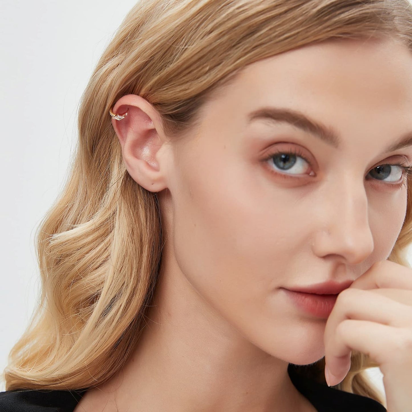 A fashion editorial photograph featuring the Lozenge Pavé Hoop by LTM Jewels. The model is seen wearing the 18K gold geometric hoop, illustrating its role as a cinematic heirloom and a sophisticated statement of modern luxury. The contrast between the edgy lozenge shape and the brilliant diamond path is prominent, illustrating the Architectural Rhythm design philosophy. This image captures the atmospheric grace of the piece, showing how it adds a structural glow to a high-end luxury collection.