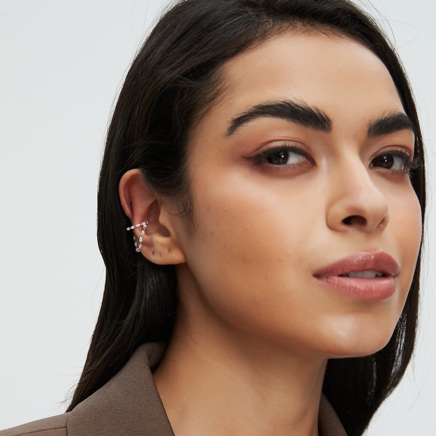 Model wearing a high-shimmer marquise diamond chain dangle cuff