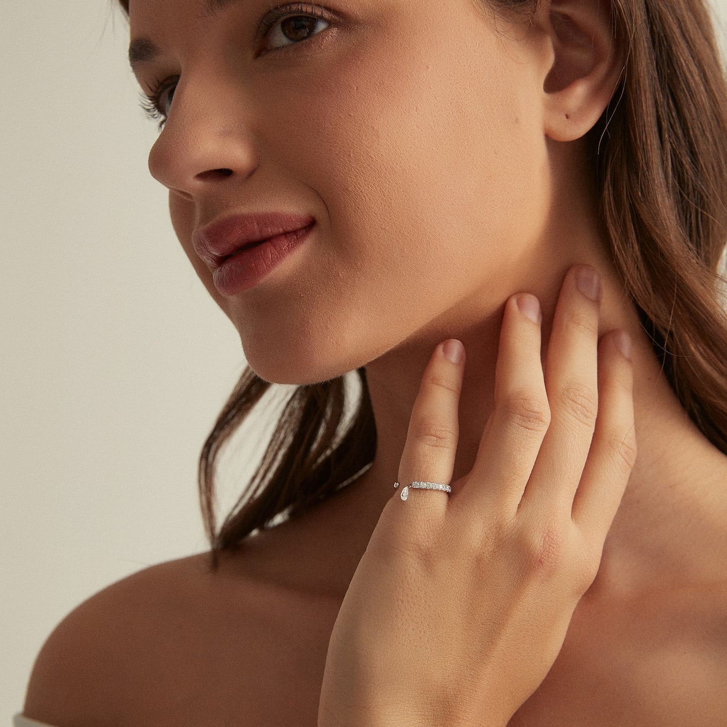 Model wearing the Radiant Drift pear diamond pave dangle ring in 18K gold