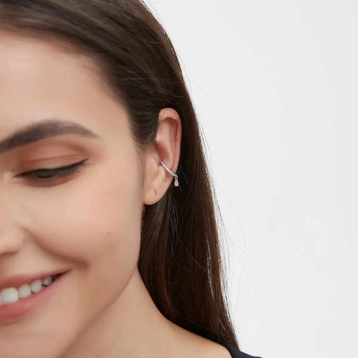 Model wearing the Pink Pear Diamond Ear Cuff from the Blush Reverie collection. The floating pink pear-cut diamond and sculptural gold silhouette create cinematic brilliance, romantic movement, and modern luxury editorial jewelry styling.