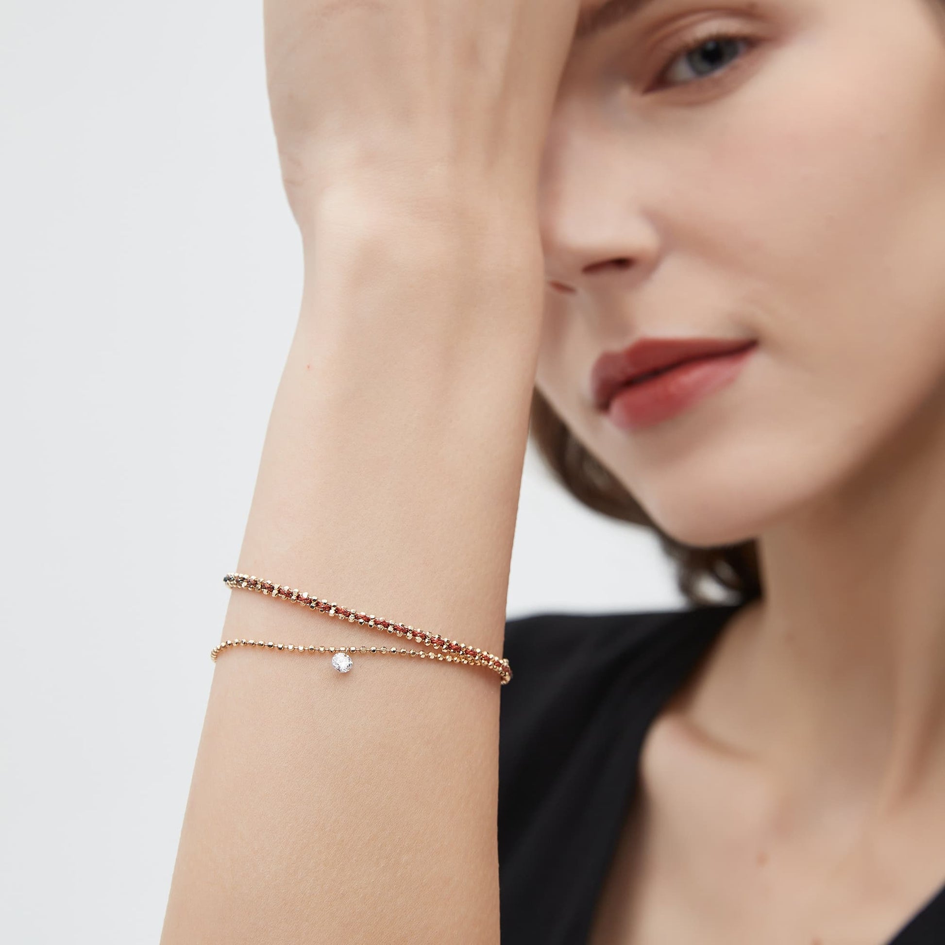Model wearing the single diamond woven bead bracelet for a minimalist wrist look.