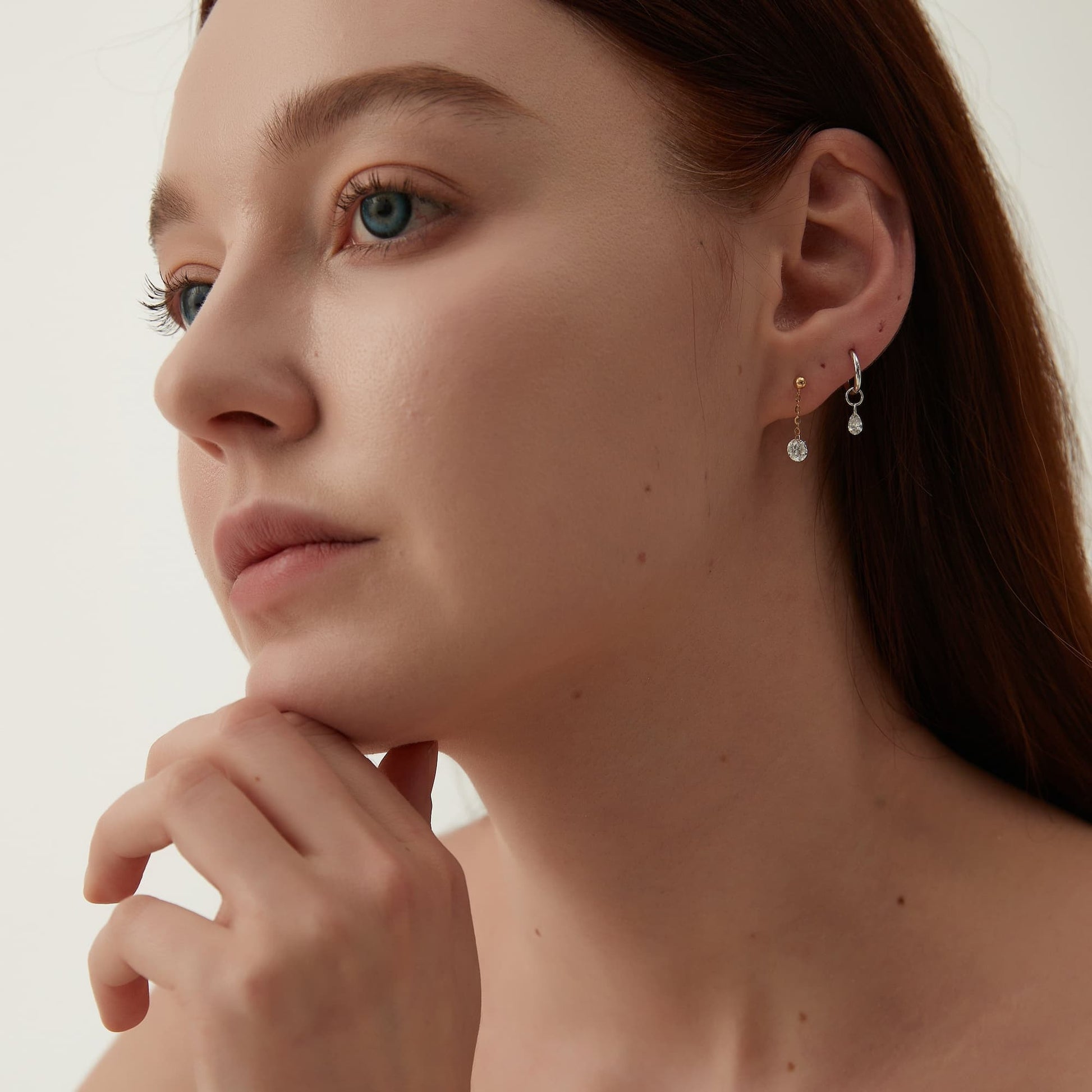 Model wearing Celestial Drift single pear-cut white diamond charm.