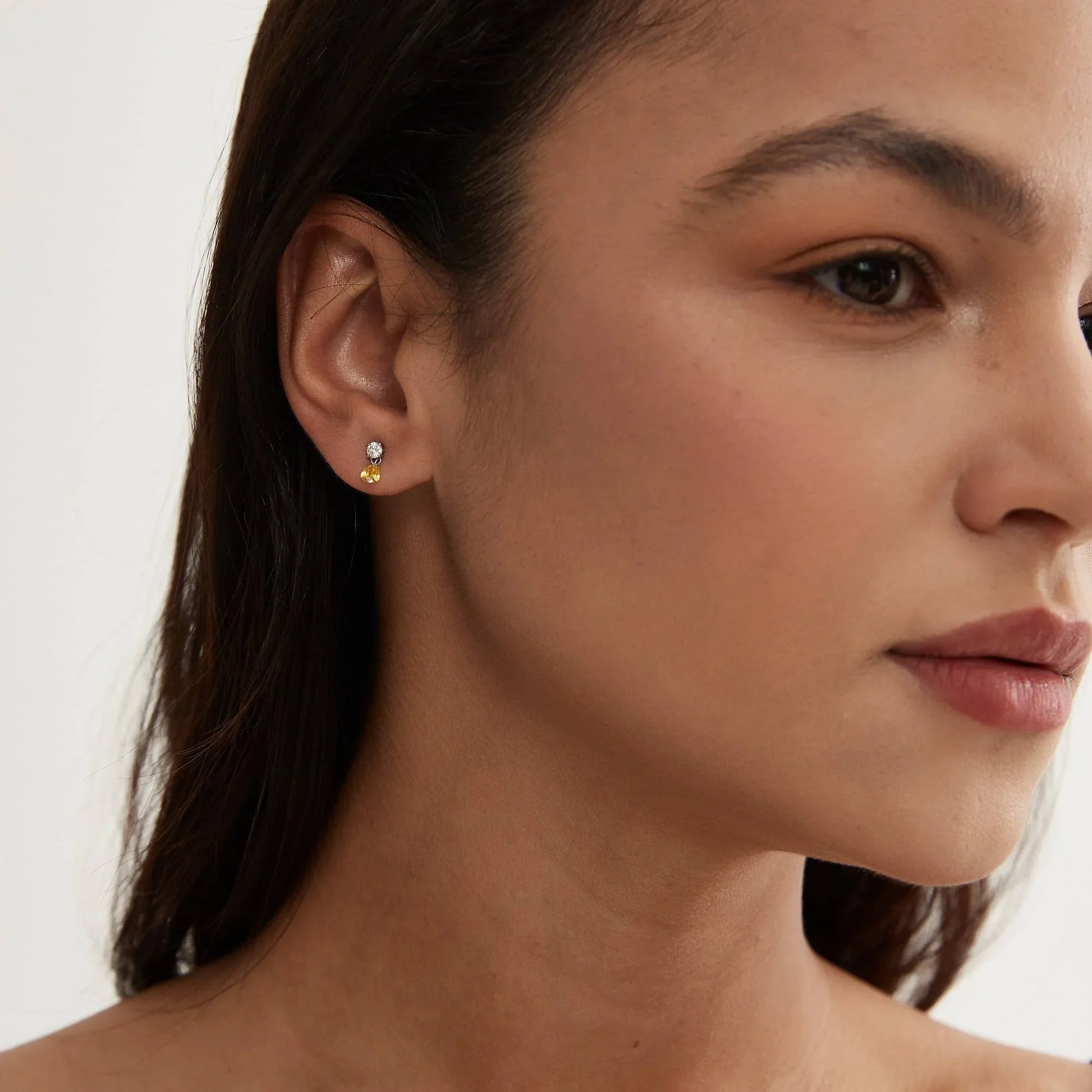 Model wearing Radiant Drift yellow marquise and round diamond threaded dangle stud.