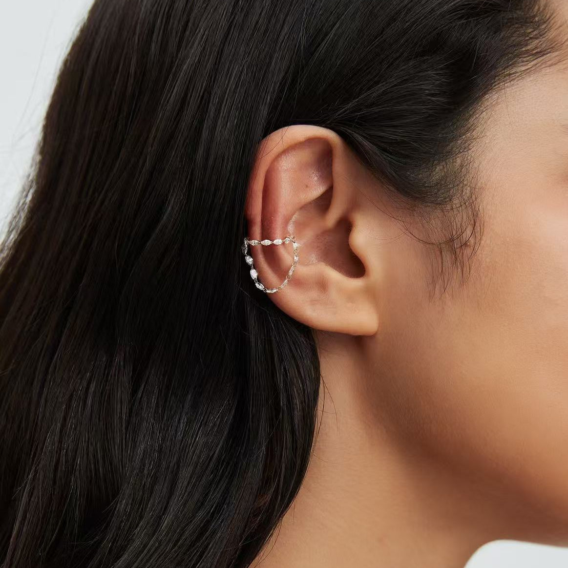 Lifestyle styling of a luxury ear stack featuring a marquise cascade cuff