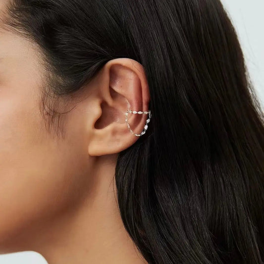 Lifestyle styling of a luxury ear stack featuring a marquise cascade cuff