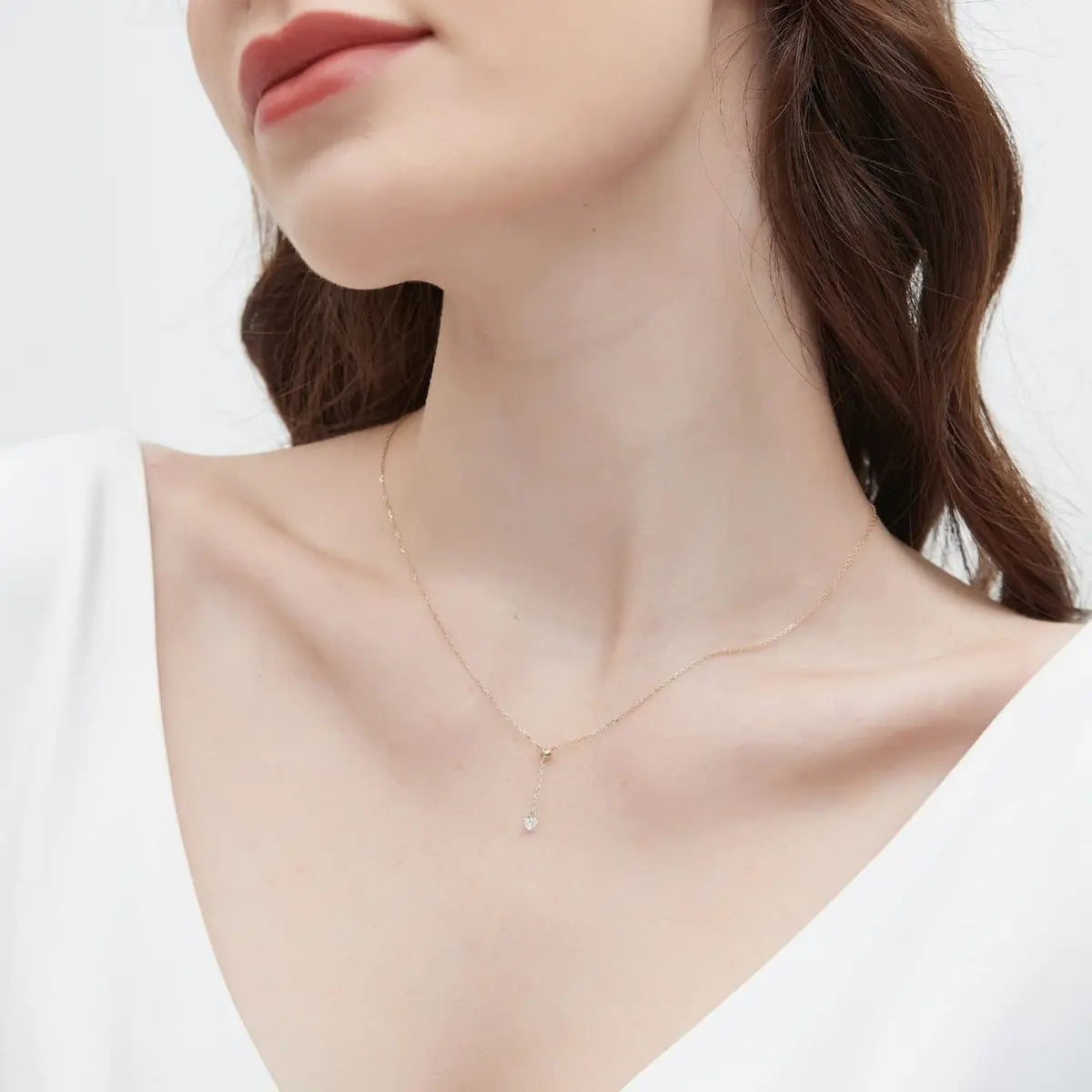 A detailed macro close-up focusing on the 0.2ct round brilliant diamond and the adjustable sliding bead mechanism of the Radiant Drift Necklace. The high-definition image reveals the exceptional fire and crystalline fire of the D-E color diamond and the precision of the 18K solid gold settings. The close-up emphasizes the innovative functional design that allows the stone to glide effortlessly along the chain, showcasing the master craftsmanship and architectural quality of LTM Jewels.
