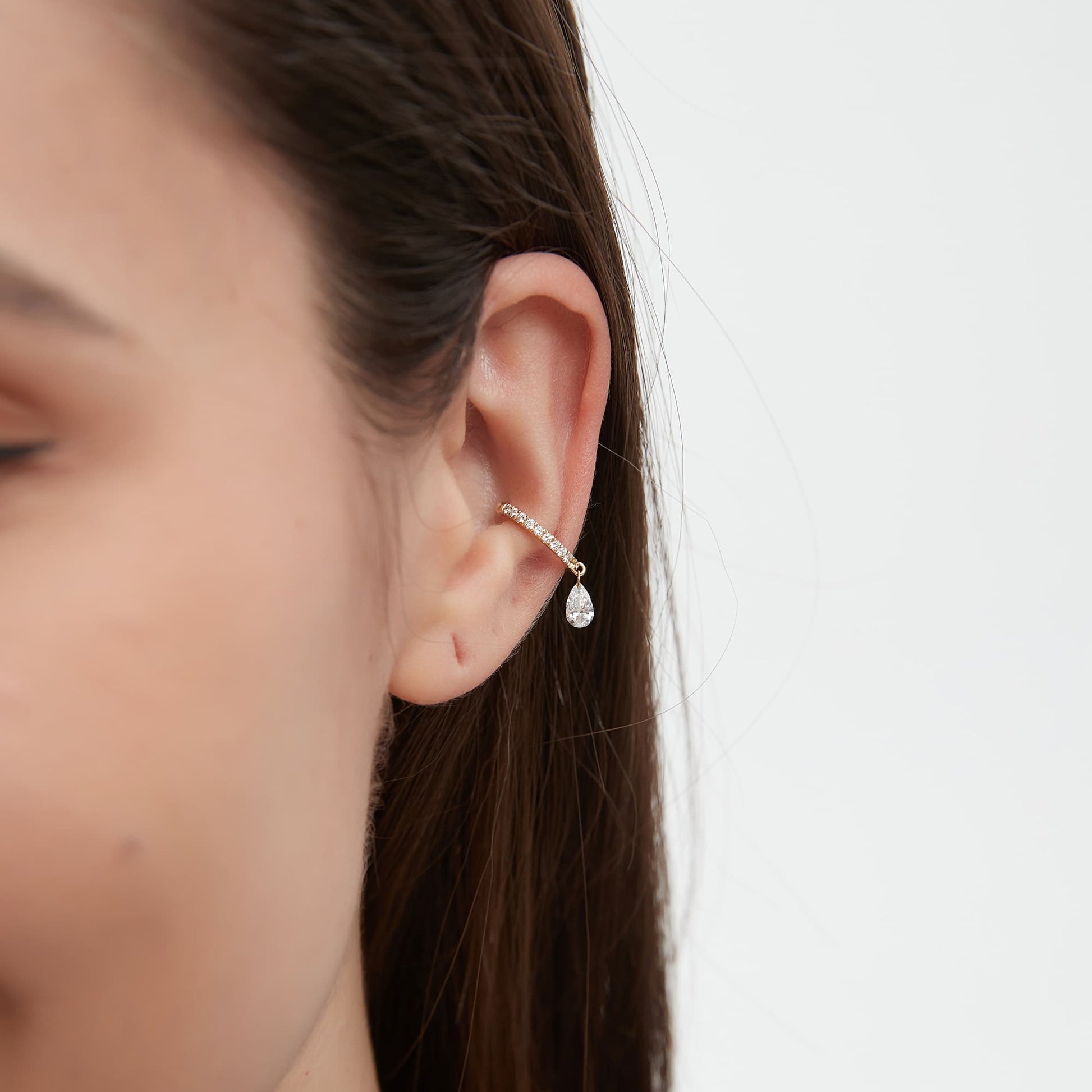 Close-up detail of a VVS pear-cut lab grown diamond on a gold cuff