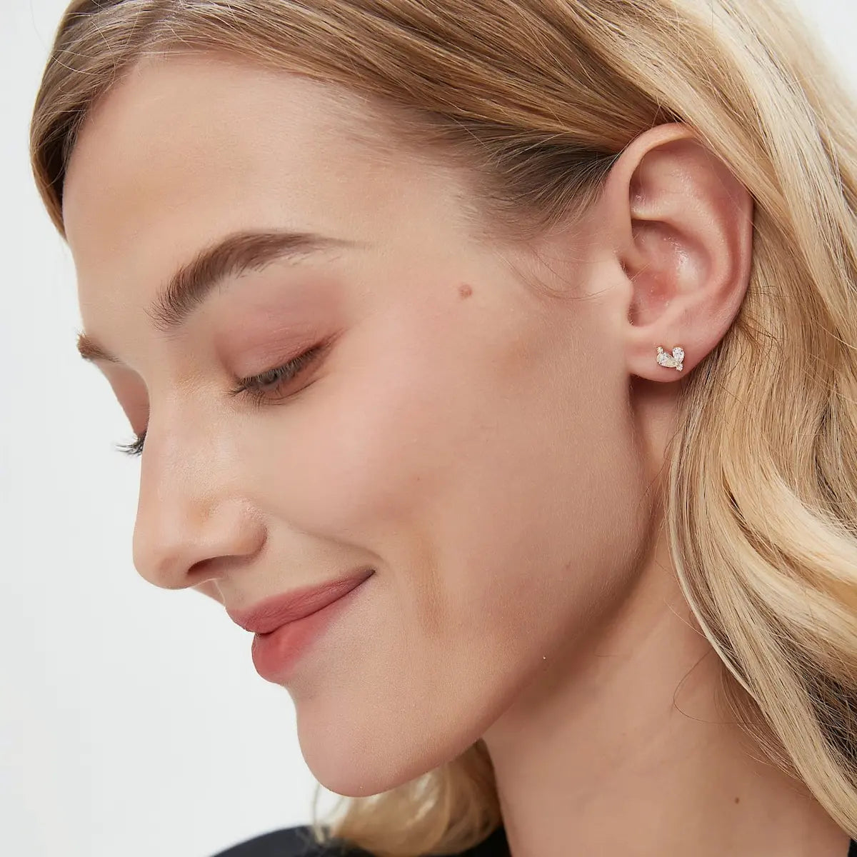 A technical side profile view of the Pear Diamond Threaded Stud. This image highlights the structural integrity of the 18K solid gold AU750 construction and the professional threaded screw back engineered for a secure 24/7 permanent-wear fit. The profile view showcases the comfortable post length and the depth of the pear-diamond setting, ensuring stability and a flush fit against the ear. The consistent high-polish finish and the alignment of the 0.40ctw diamonds are clearly visible, showcasing quality.