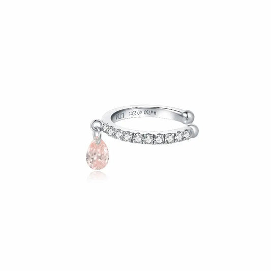 18K solid gold pink pear diamond ear cuff featuring a floating pear-shaped pink lab-grown diamond accented by shimmering white diamonds. The sculptural no-piercing cuff creates romantic brilliance, fluid movement, and modern luxury curated ear styling.