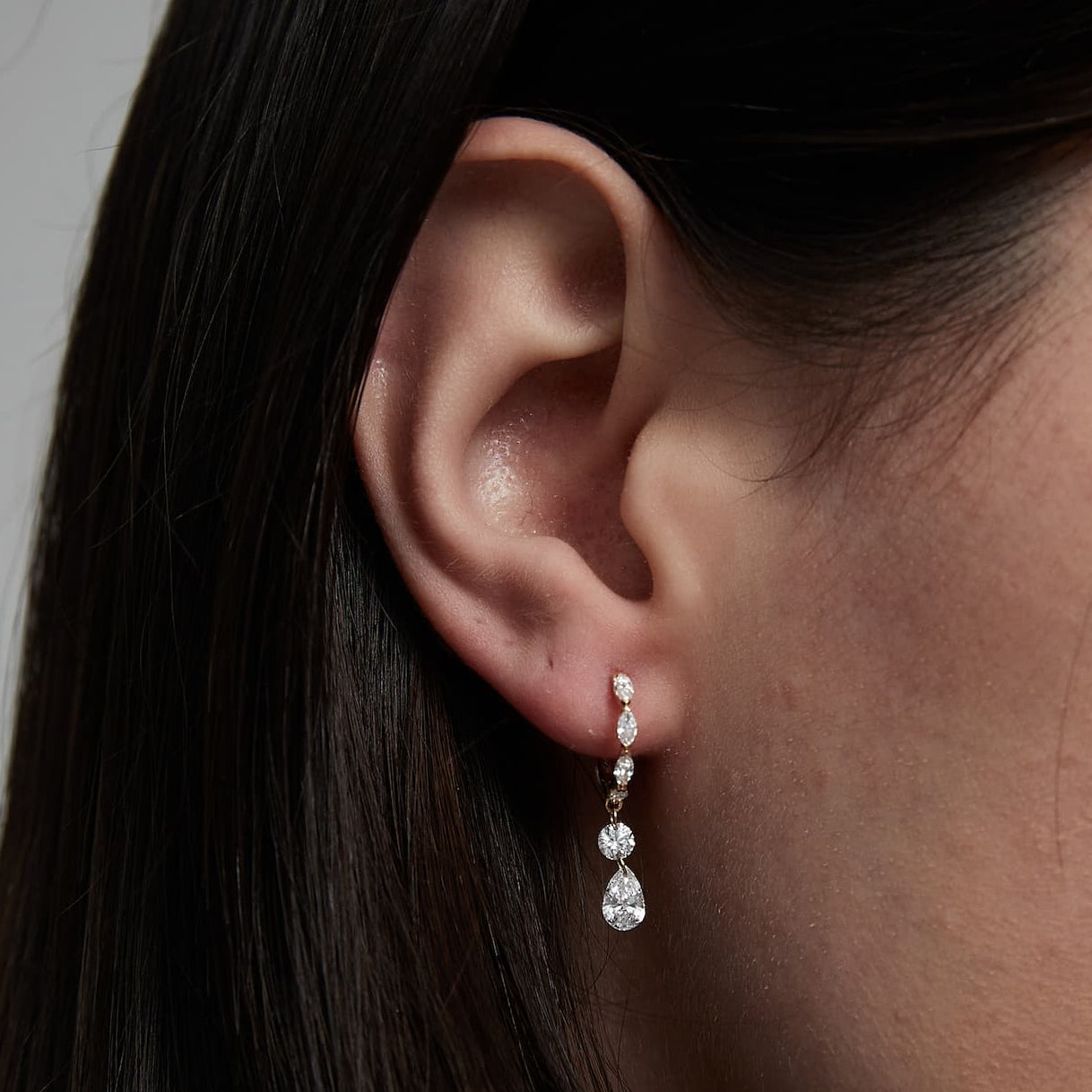 Close-up detail of the 0.35ct pear and 0.15ct round diamond floating dangle