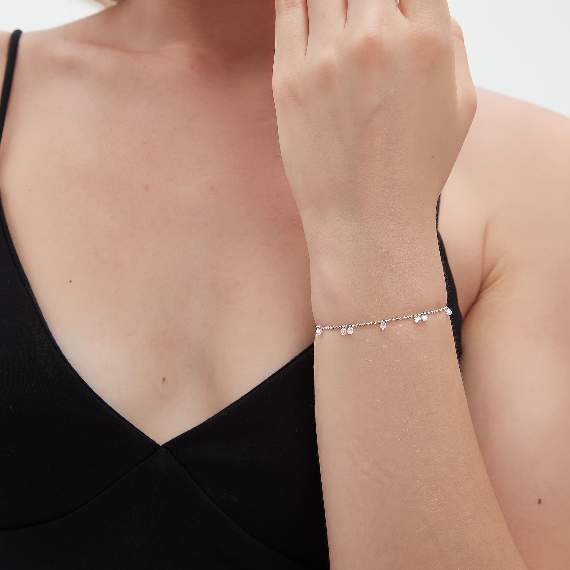 Close-up detail of 0.10ct drilled pink and white diamonds on a gold bead chain