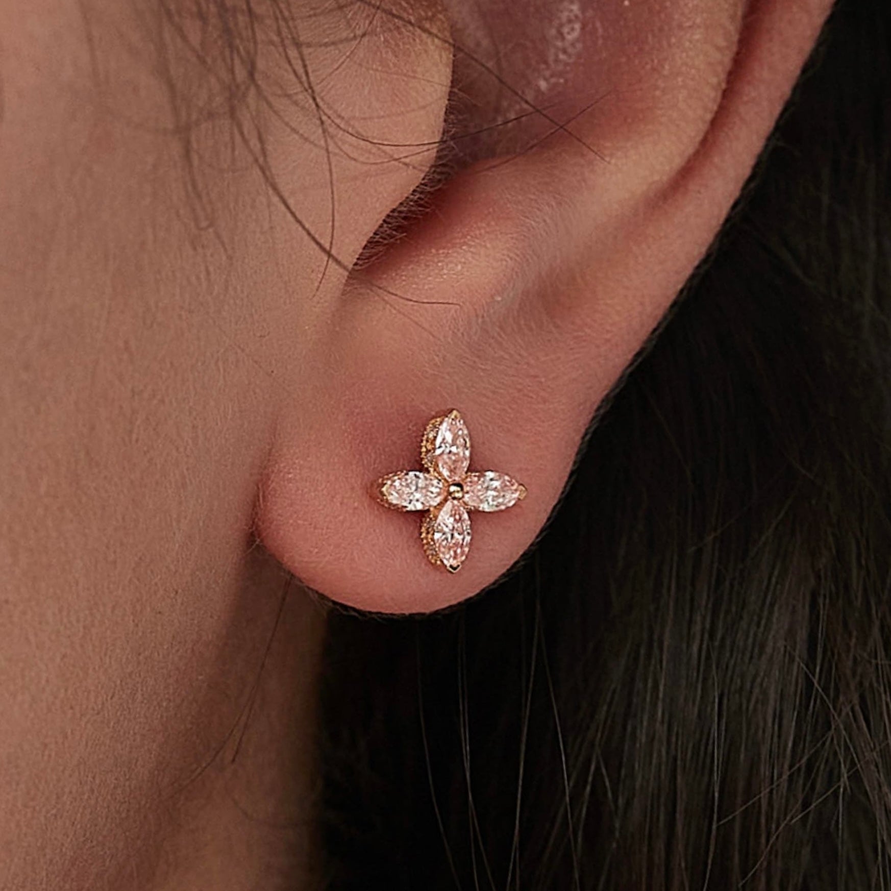 Close-up detail of the four-leaf clover stud with Fancy Pink lab grown diamonds