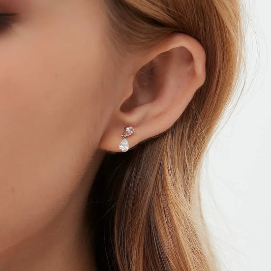 Pink pear lab diamond threaded stud worn on ear in 18K gold, showcasing elegant color contrast and secure screw-back fit
