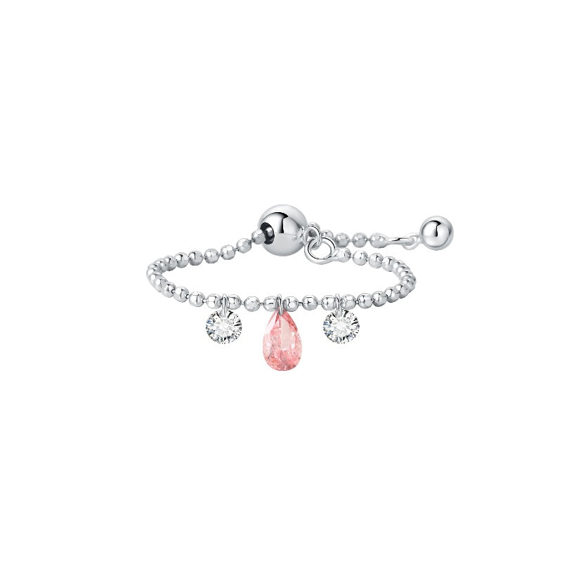 A high-resolution studio photograph of the Trio Diamond Pink Pear White Round Chain Ring from the LTM Jewels Radiant Drift collection. Handcrafted in 18K solid gold, the ring features a 0.13ct fancy pink pear diamond centerpiece flanked by two 0.08ct brilliant white round diamonds on a flexible chain band. The image highlights the high-polish AU750 gold finish and the exceptional fire of the 0.29ctw diamonds against a professional clean background.