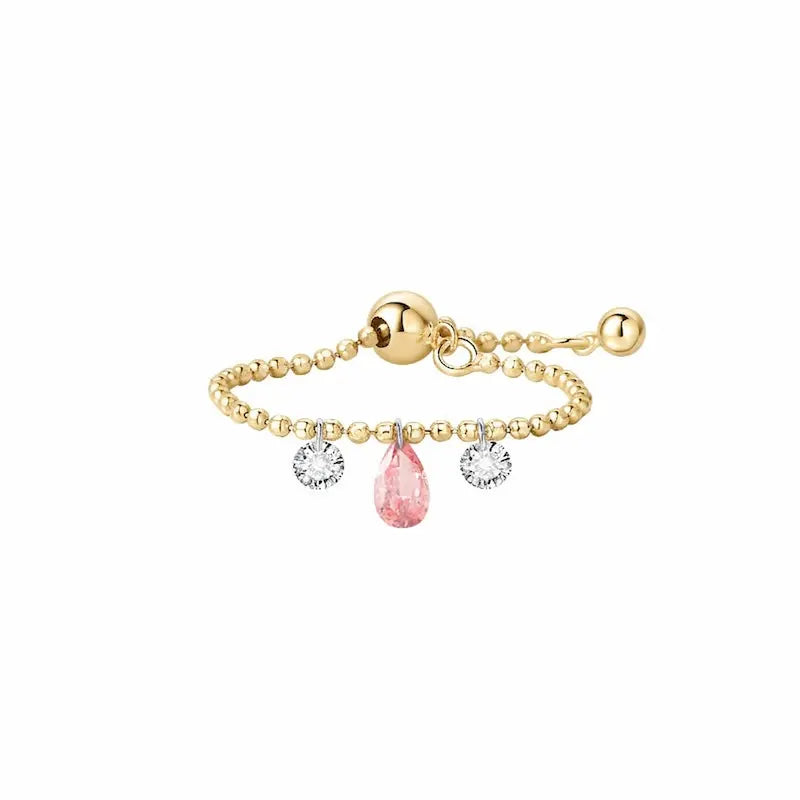 A high-resolution studio photograph of the Trio Diamond Pink Pear White Round Chain Ring from the LTM Jewels Radiant Drift collection. Handcrafted in 18K solid gold, the ring features a 0.13ct fancy pink pear diamond centerpiece flanked by two 0.08ct brilliant white round diamonds on a flexible chain band. The image highlights the high-polish AU750 gold finish and the exceptional fire of the 0.29ctw diamonds against a professional clean background.