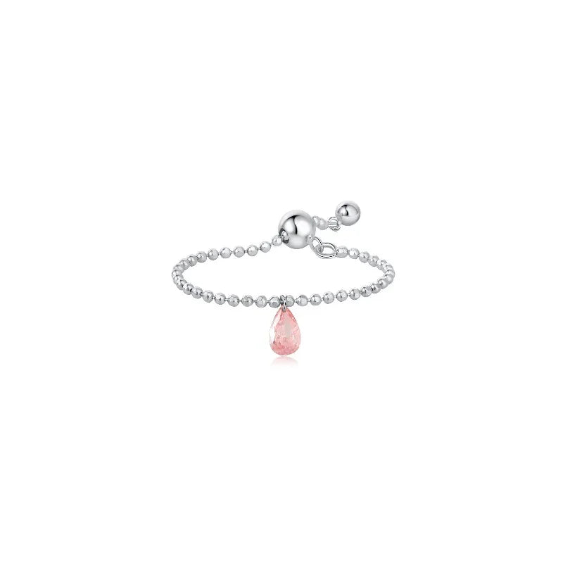 LTM & CO. Pink Single Pear Diamond Chain Ring from the Radiant Drift collection. Features a floating pink lab-grown pear diamond laser-drilled onto a delicate 18K solid gold chain. Modern, minimalist, and sustainable fine jewelry showcasing architectural rhythm and weightless elegance.