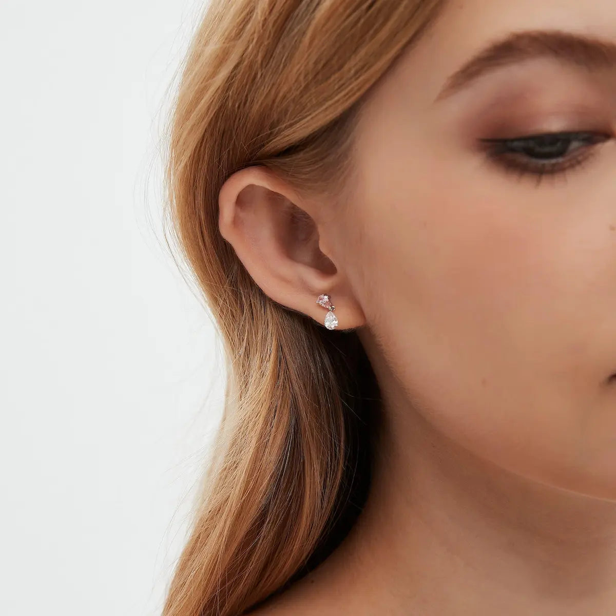 Model wearing pink pear and white lab diamond threaded stud earrings in 18K gold by LTM & CO.™, styled with romantic modern aesthetic