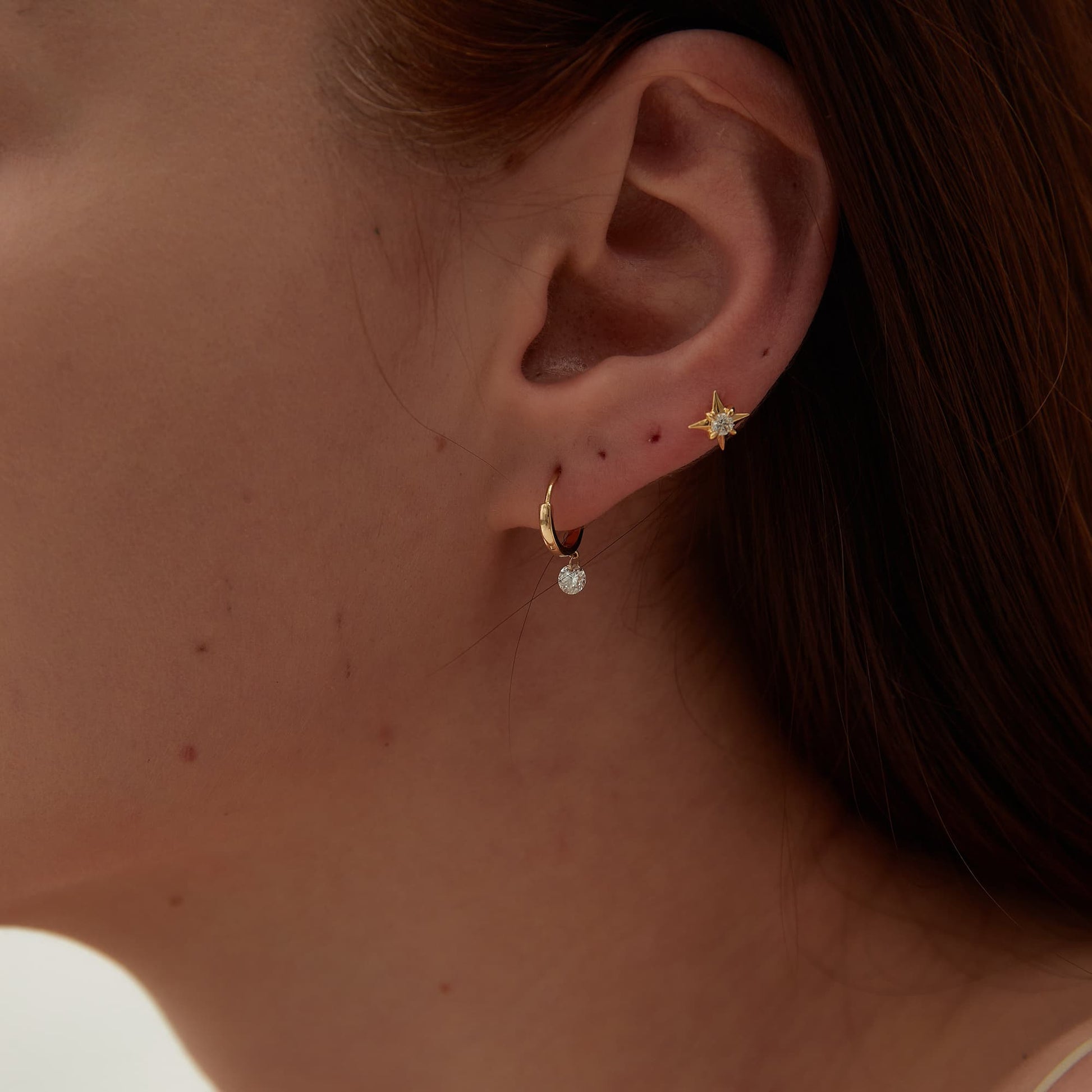 Side profile showing the secure threaded screw back and solid gold star structure.