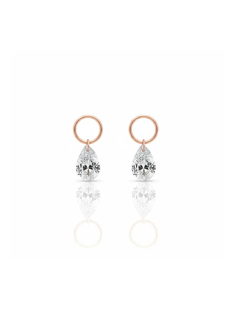 A single pear-cut lab-grown diamond charm for earrings, expertly laser-drilled for a unique floating effect in 18K solid gold. This minimalist jewelry piece by LTM Jewels showcases the brilliance of a VVS-VS clarity, D-E color diamond without a traditional setting. Perfect as a modular jewelry accessory for curated ear stacks, this 18K gold diamond dangle charm offers a weightless, sophisticated aesthetic for modern luxury lovers seeking ethical, sustainable fine jewelry.