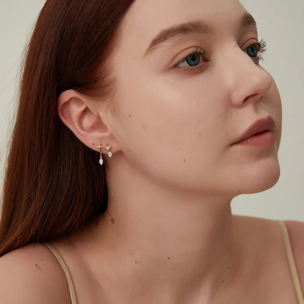 Side profile of the Star Floating Marquise Dangle Earring. Showcases the secure threaded stud mechanism and the absence of traditional settings around the marquise diamond. This architectural transparency allows for 360-degree light entry, highlighting the stone's depth and the sleek, minimalist silhouette of the 18K solid gold design.