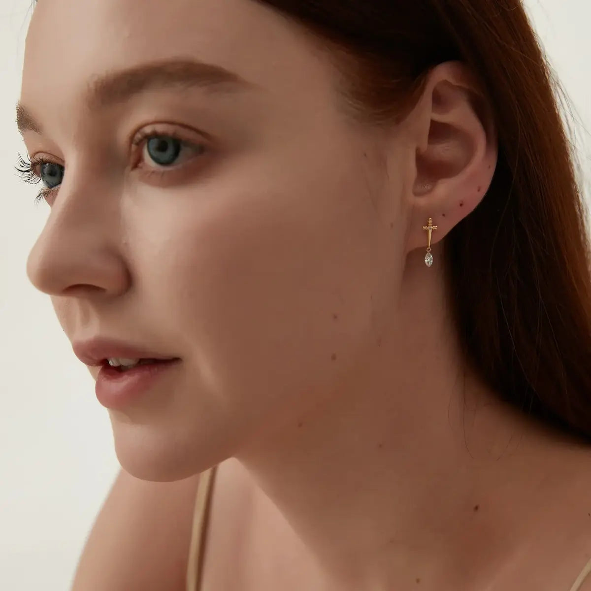 Model wearing Sword Marquise Dangle Threaded Stud Earrings in 18K gold by LTM & CO.™, styled with bold modern edge.