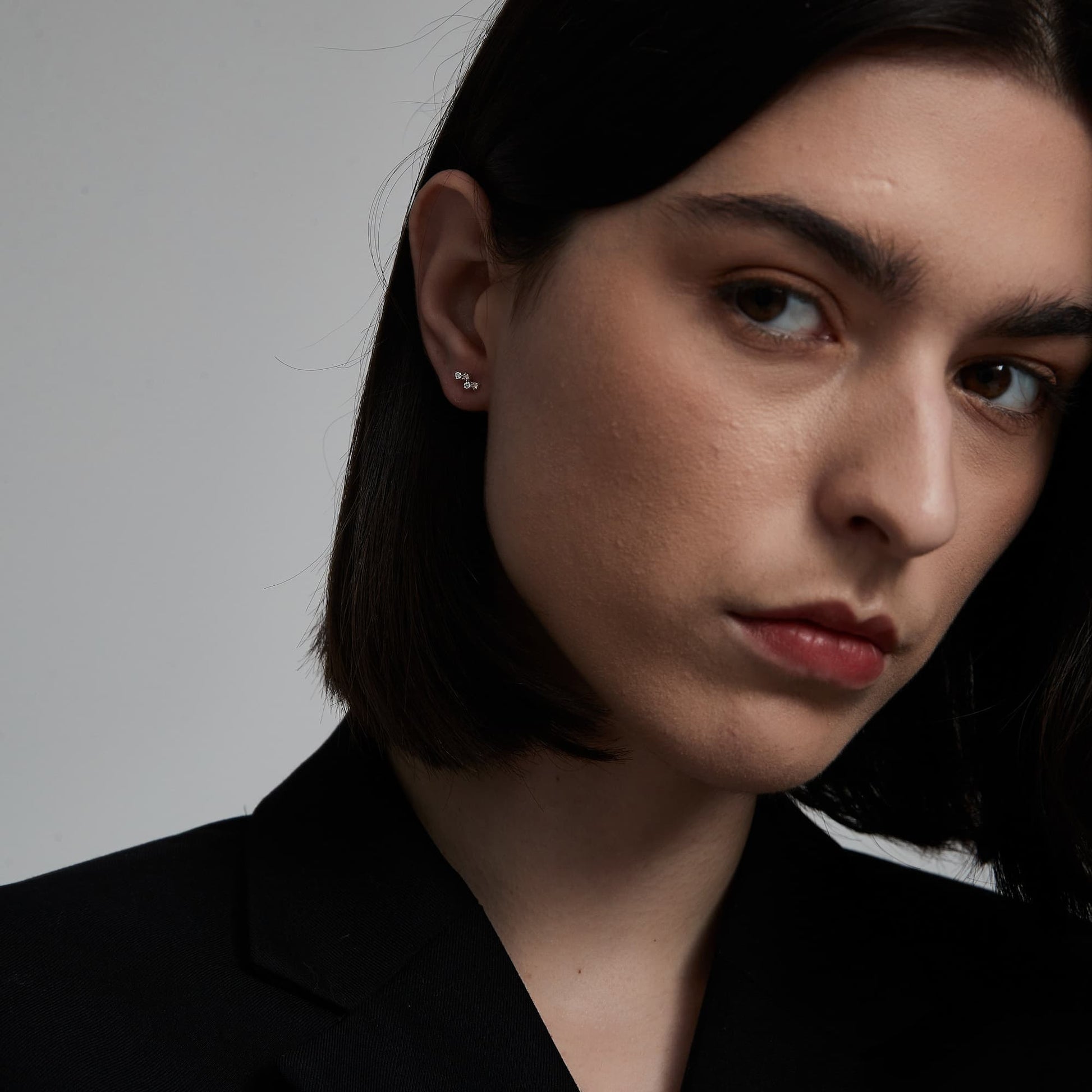 Fashion model wearing LTM JEWELS pink diamond blush stud in 18K solid gold