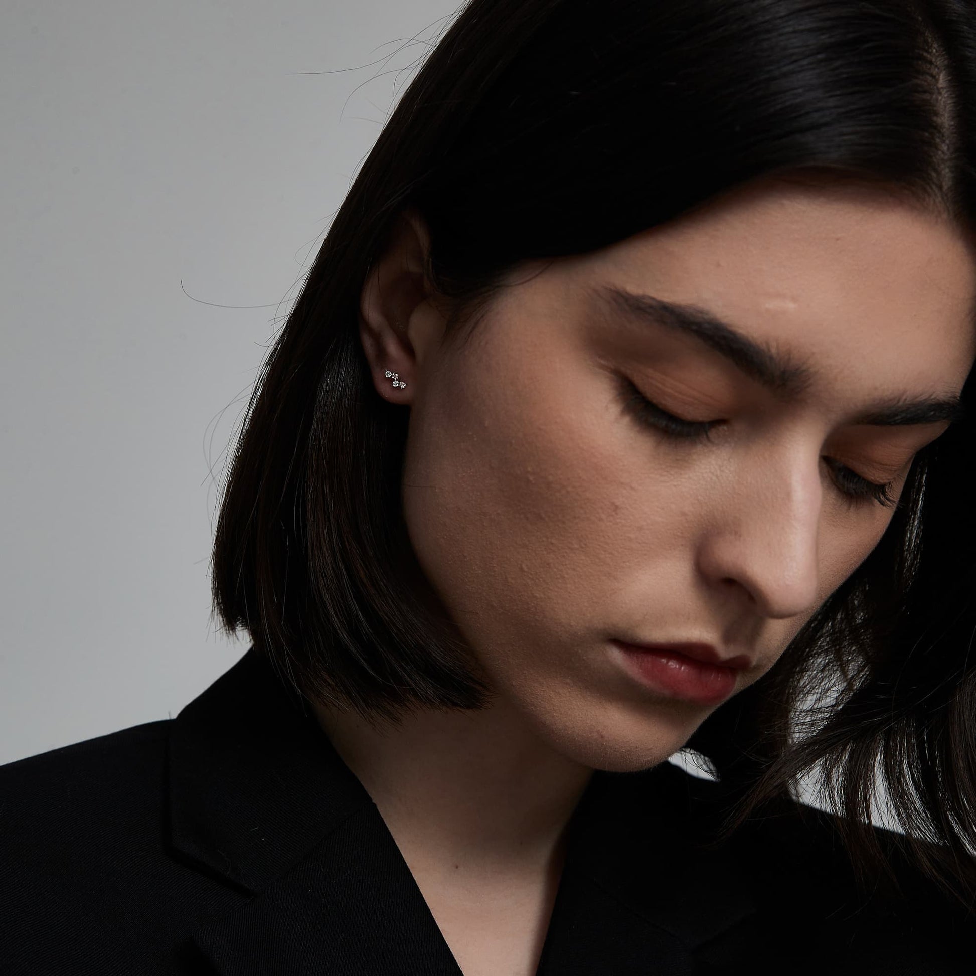 Model wearing The Blush pink diamond threaded stud in a curated ear piercing stack