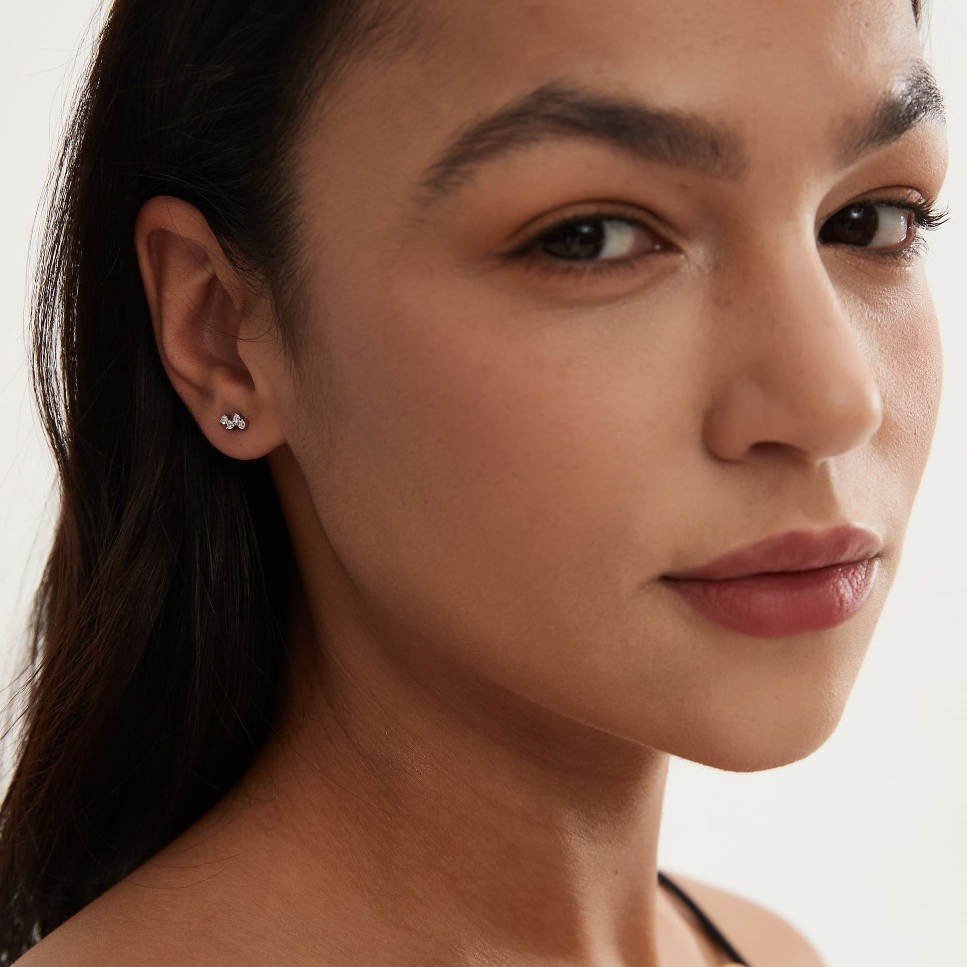 Fashion model wearing LTM JEWELS white diamond pure stud in 18K solid gold