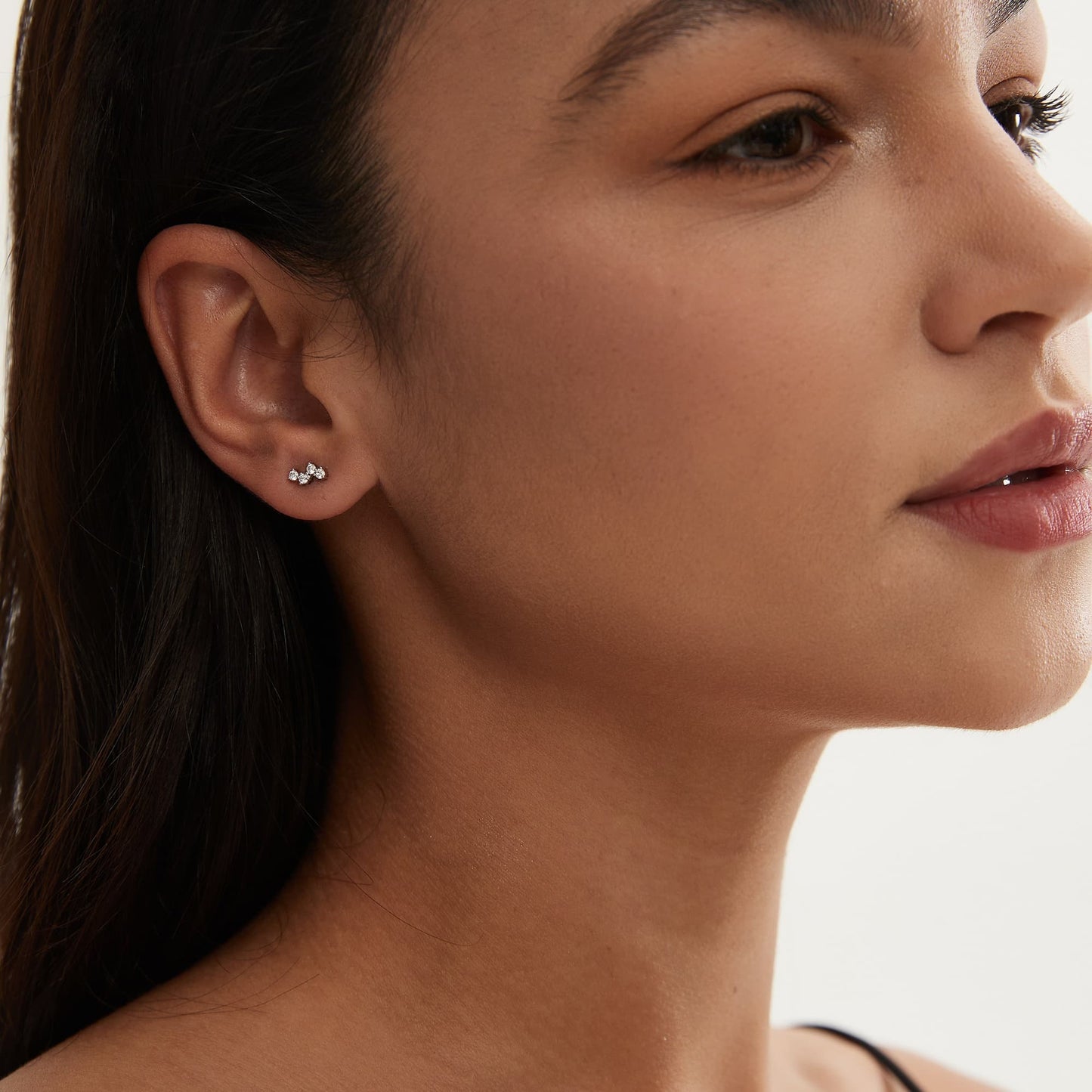 Model wearing The Pure white diamond threaded stud in a curated ear piercing stack