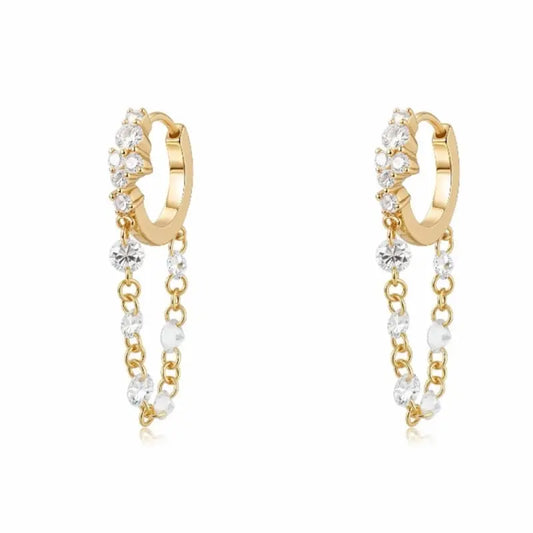 Luxurious 18K solid gold Radiant Cascade diamond dangle hoop earring featuring a brilliant cluster-set huggie paired with a shimmering waterfall chain of six floating lab-grown diamonds. This 0.50ctw fine jewelry piece by LTM Jewels showcases a sophisticated architectural design with VVS-VS clarity and D-E color diamonds. Perfect for modern curated ear stacks, this high-polish 18K gold clicker hoop offers a rhythmic glow and sustainable luxury for discerning jewelry collectors.
