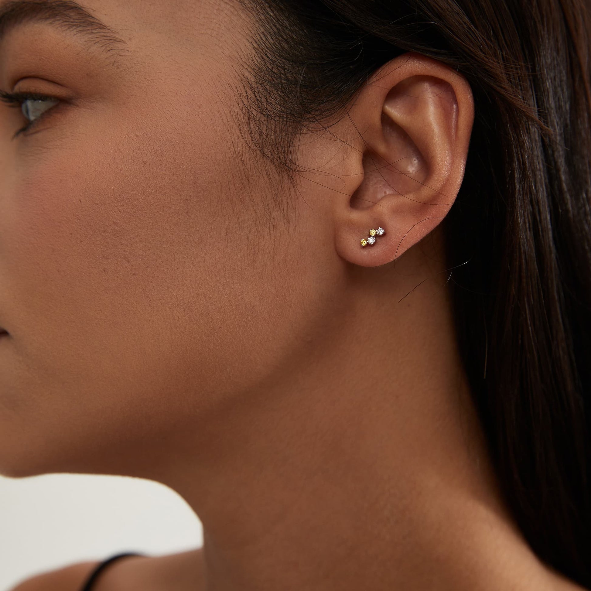 Fashion model wearing LTM JEWELS yellow diamond solar stud in 18K solid gold