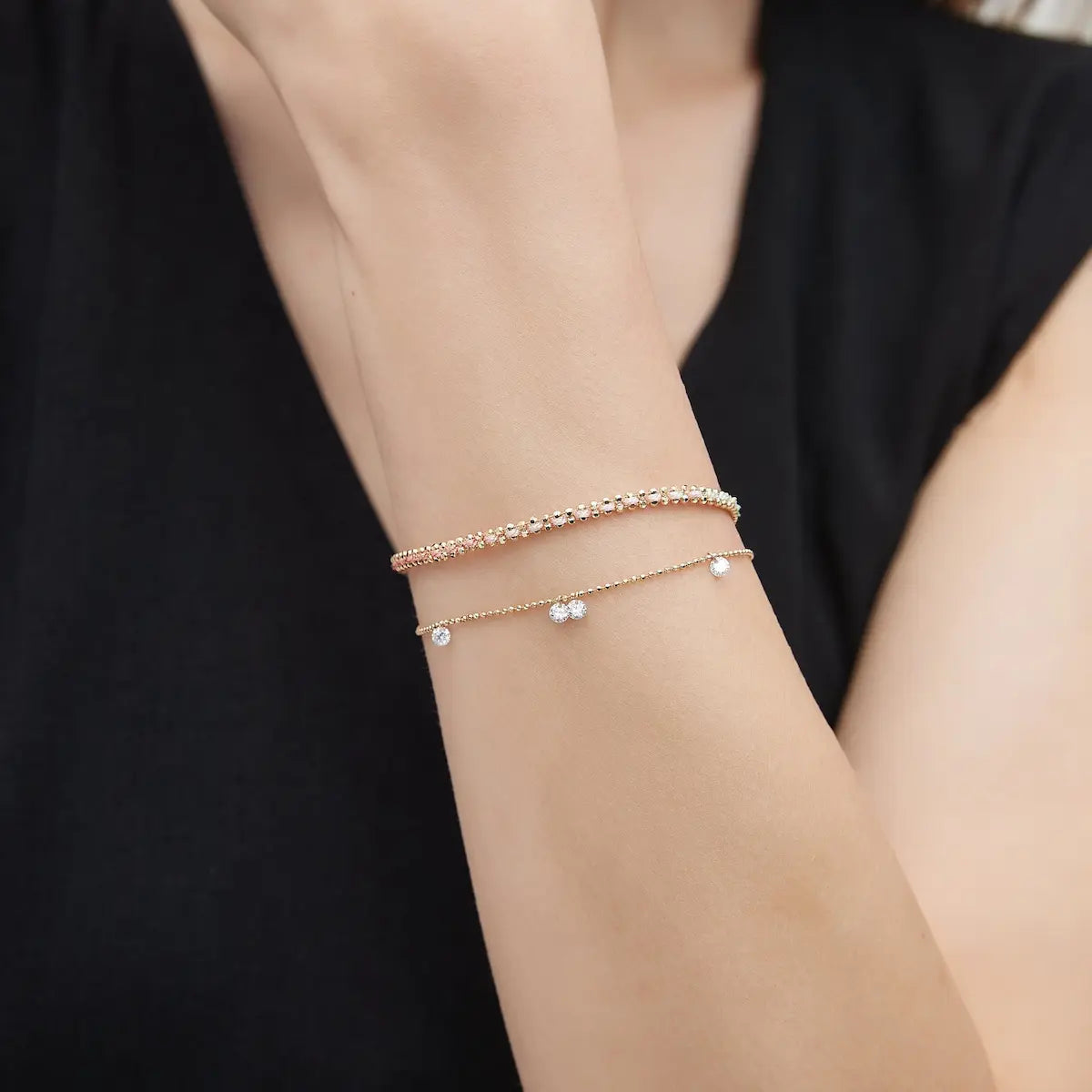 Side view of the Floating Diamond Rope Bracelet crafted in solid 18K gold showcasing the adjustable extension chain and woven rope bead construction. The lightweight sculptural bracelet is engineered for comfortable daily wear and refined modern luxury wrist styling.